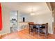 Bright dining area with wood flooring and a view into the kitchen at 7932 Eagle Valley Pass, Indianapolis, IN 46214