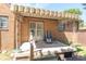 Back porch with awning, chair, and steps leading to the yard at 532 E Mills Ave, Indianapolis, IN 46227