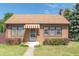 Brick house with brown awning, landscaping, and walkway at 532 E Mills Ave, Indianapolis, IN 46227