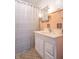 Retro bathroom with peach tile, updated vanity, and shower at 532 E Mills Ave, Indianapolis, IN 46227