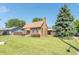 Brick house with brown awning, landscaping, and walkway at 532 E Mills Ave, Indianapolis, IN 46227
