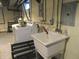 Unfinished basement laundry area with washer, dryer, and utility sink at 431 Vestal Rd, Plainfield, IN 46168
