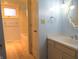Light blue bathroom with vanity, bathtub, and wood flooring at 431 Vestal Rd, Plainfield, IN 46168