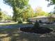 Landscaped front yard with circular flower bed and spruce trees at 431 Vestal Rd, Plainfield, IN 46168