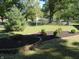Landscaped front yard with manicured flowerbeds and a spruce tree at 431 Vestal Rd, Plainfield, IN 46168
