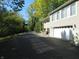 Beige house with attached garage and driveway, surrounded by lush greenery at 431 Vestal Rd, Plainfield, IN 46168