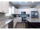 Modern kitchen with white cabinets, granite counters, and stainless steel appliances at 6611 Ventnor Pl, Indianapolis, IN 46217