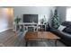 Living area with hardwood floors, TV stand, and comfortable seating at 6611 Ventnor Pl, Indianapolis, IN 46217