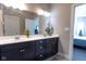 Double vanity bathroom with modern fixtures and a large mirror at 6611 Ventnor Pl, Indianapolis, IN 46217