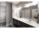 Double vanity bathroom with updated fixtures and a view of bedroom at 6611 Ventnor Pl, Indianapolis, IN 46217