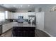 Modern kitchen with white cabinets, granite island, and stainless steel appliances at 6611 Ventnor Pl, Indianapolis, IN 46217