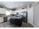 Updated kitchen with white cabinets, granite island, and stainless steel appliances at 6611 Ventnor Pl, Indianapolis, IN 46217