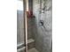 Walk-in shower with tiled walls and a built-in seat at 6611 Ventnor Pl, Indianapolis, IN 46217