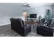 Relaxing living room with hardwood floors, sectional sofa, and large TV at 6611 Ventnor Pl, Indianapolis, IN 46217