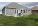 Brick home with backyard patio and grassy lawn at 6611 Ventnor Pl, Indianapolis, IN 46217