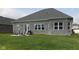 Brick home with backyard patio and grassy lawn at 6611 Ventnor Pl, Indianapolis, IN 46217
