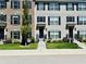 Two-story townhouses with brick and siding, black shutters, and landscaping at 3534 Brampton Ln, Westfield, IN 46074