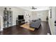 Open living room with hardwood floors, gray sofa, and a built-in shelving unit at 1938 E 11Th St, Indianapolis, IN 46201
