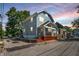 Side view of a charming two-story home with gray siding and a red base at 1938 E 11Th St, Indianapolis, IN 46201