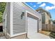 Detached gray garage with white door and exterior lights at 1938 E 11Th St, Indianapolis, IN 46201