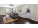 Spacious living room with hardwood floors, gray sofa, and a modern ceiling fan at 1938 E 11Th St, Indianapolis, IN 46201