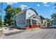 Side view of a charming two-story home with gray siding and a red base at 1938 E 11Th St, Indianapolis, IN 46201