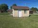 Small wooden shed with a door and window, located in the backyard at 610 W Monroe St, Alexandria, IN 46001