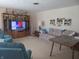 Living room with sofa, TV, and large puzzle at 610 W Monroe St, Alexandria, IN 46001