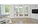 Bright sunroom with French doors, hardwood floors, and comfortable seating at 2838 Silverwood Ln, Greenwood, IN 46143