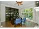 Home office with built-in bookcase, desk, and hardwood floors at 2838 Silverwood Ln, Greenwood, IN 46143
