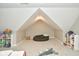 Bright bonus room with sloped ceilings, plush beanbag chair and built-in shelving at 2838 Silverwood Ln, Greenwood, IN 46143