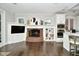 Kitchen features a brick fireplace, white cabinets, and hardwood floors at 2838 Silverwood Ln, Greenwood, IN 46143