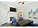 Home office with fireplace, desk, and hardwood floors at 2838 Silverwood Ln, Greenwood, IN 46143