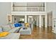 Open living room with hardwood floors, sectional sofa, and high ceilings at 2838 Silverwood Ln, Greenwood, IN 46143