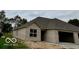 Tan brick home with gray roof, attached garage, and landscaping at 980 Paris Dr, Franklin, IN 46131