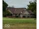 House with brown roof, stone accents, and deck overlooking golf course at 980 Paris Dr, Franklin, IN 46131