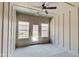 Sunroom with wood-paneled walls, windows, and access to the backyard at 2841 Grandview Ln, Greenwood, IN 46143