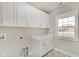 Laundry room with white cabinets and ample counter space at 2841 Grandview Ln, Greenwood, IN 46143