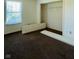 Empty bedroom with new carpet, window, and closet at 4322 Par Dr, Indianapolis, IN 46268
