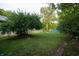 Large grassy backyard with mature trees and a partially visible pool at 2363 N Gale St, Indianapolis, IN 46218