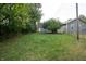 Grass yard with a detached garage and mature trees at 2363 N Gale St, Indianapolis, IN 46218