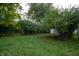 Large grassy backyard with detached garage and mature trees at 2363 N Gale St, Indianapolis, IN 46218