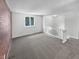 Living room with carpet, brick wall, and loft view at 2647 Sheffield Dr, Indianapolis, IN 46229