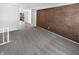 Living room with gray carpet and brick accent wall at 2647 Sheffield Dr, Indianapolis, IN 46229