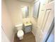 Small bathroom with toilet, sink, and light blue vanity at 2647 Sheffield Dr, Indianapolis, IN 46229
