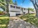Ranch home with gray siding, attached garage, and landscaping at 2647 Sheffield Dr, Indianapolis, IN 46229