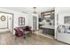 Open living room with a red leather couch and a partial kitchen view at 9644 Highgate N Cir, Indianapolis, IN 46250