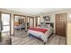 Spacious bedroom with a queen bed, mirrored closet doors, and hardwood floors at 9644 Highgate N Cir, Indianapolis, IN 46250