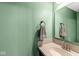 Small bathroom with a granite countertop and sage green walls at 9644 Highgate N Cir, Indianapolis, IN 46250