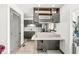 Modern kitchen with gray cabinets, quartz countertops, and stainless steel appliances at 9644 Highgate N Cir, Indianapolis, IN 46250